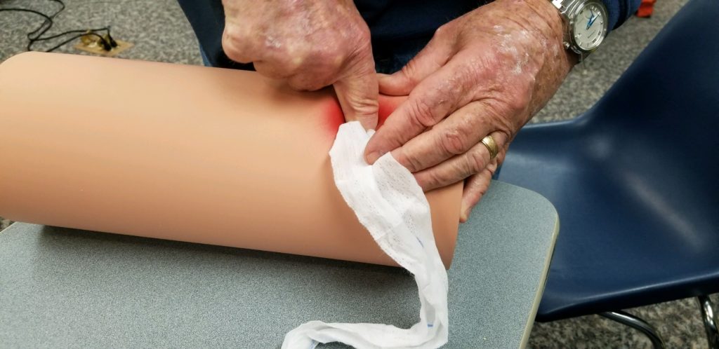 Man practicing bleeding control methods at Granby Ambulance Association