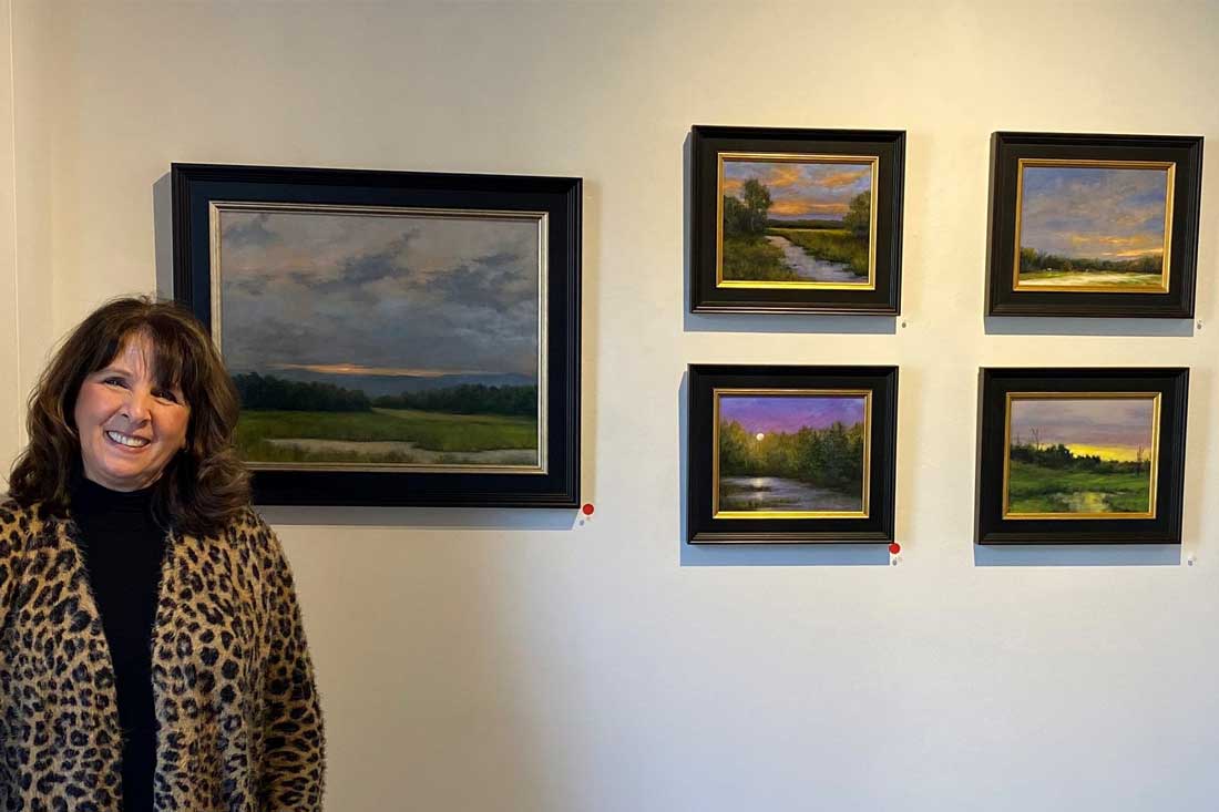 Artist, Stephanie Rogers, displaying her art work prior to GAA's fundraiser A Perfect Pairing